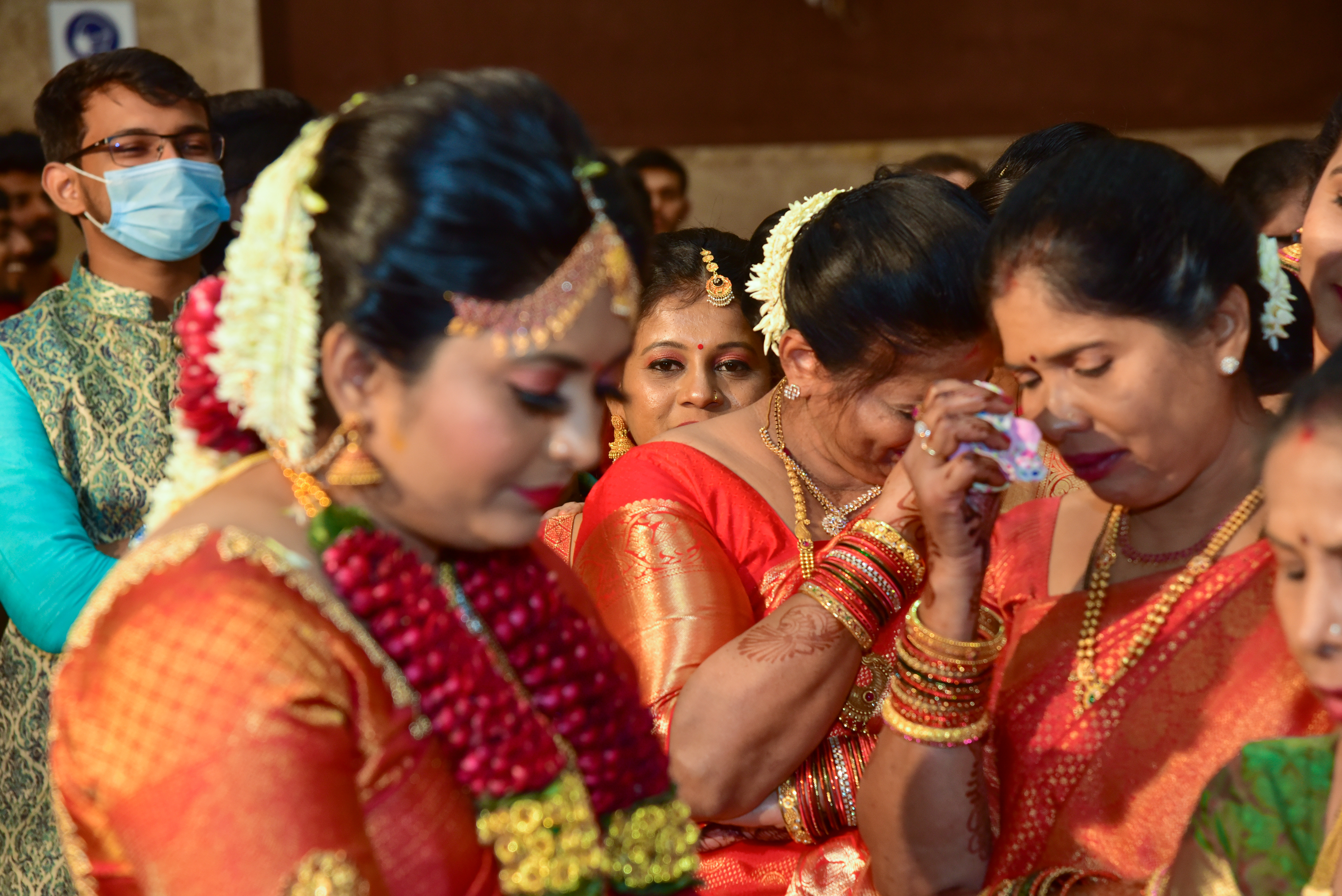 Family members joyfully participating in a lively traditional dance during a wedding reception
