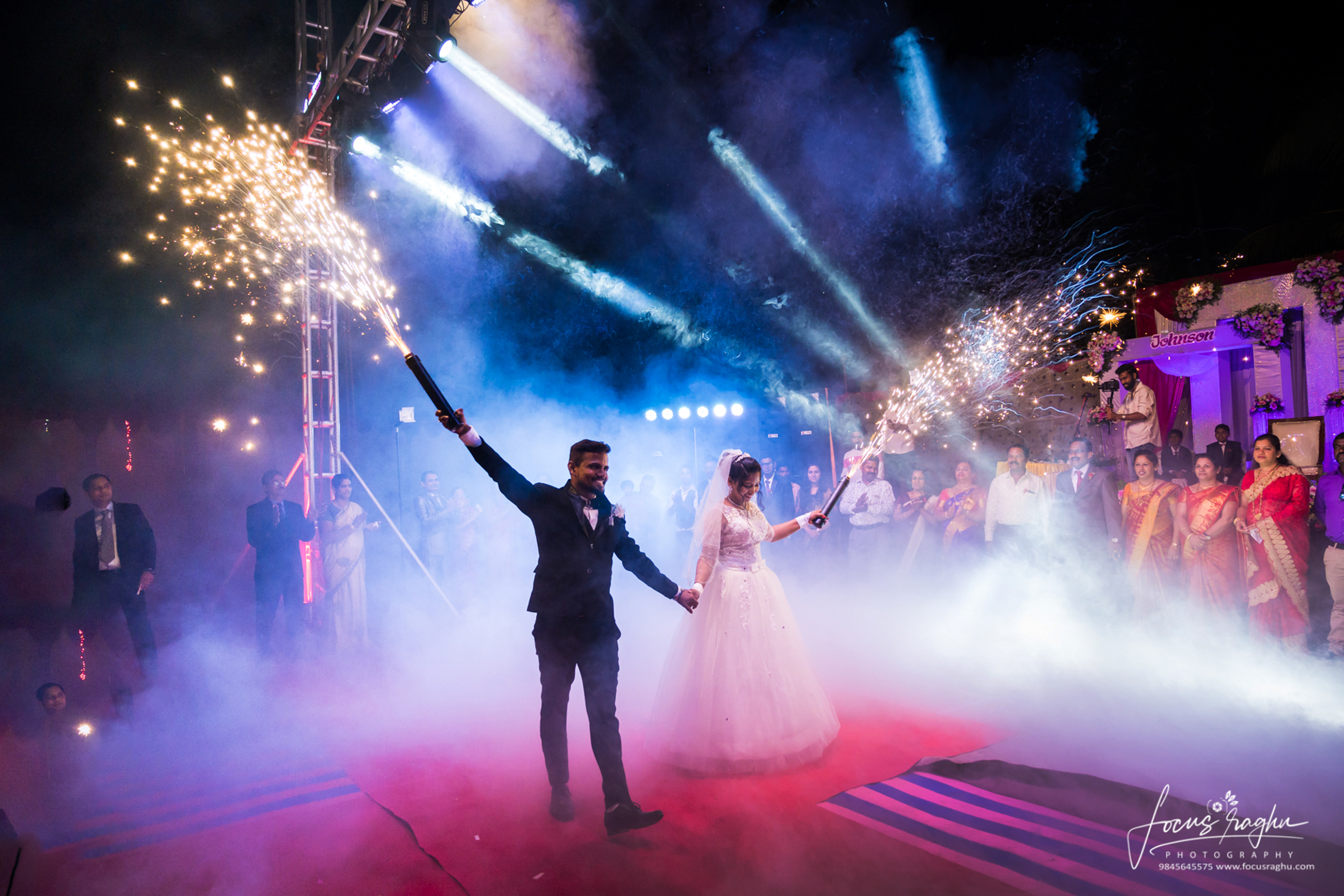 Beautifully adorned wedding venue at dusk with glowing string lights and floral arrangements