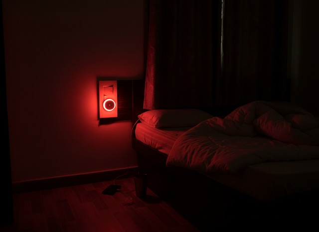 Warm Indian apartment hallway at night lit by small plug-in night lamps near a puja corner and a kids’ room door, ambient cozy lighting, devotional and playful mix, slightly dark background, cinematic soft-focus, 35mm photograph